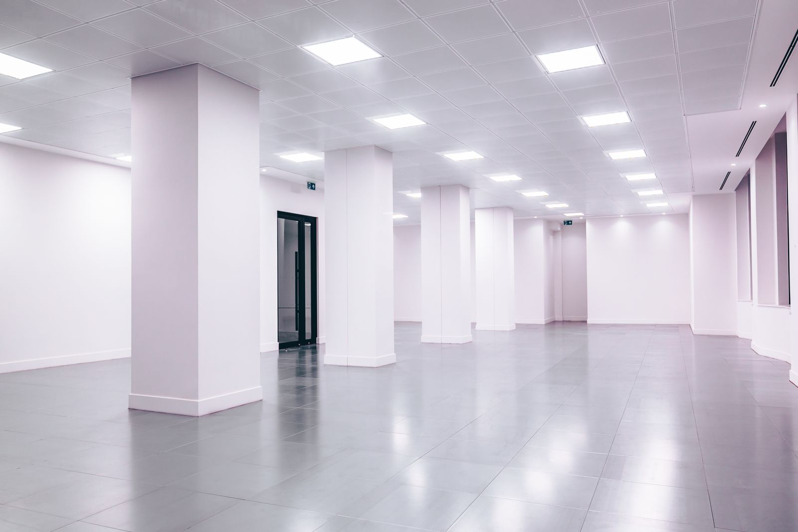 Wide-angle modern minimalist white commercial lobby with clean lines