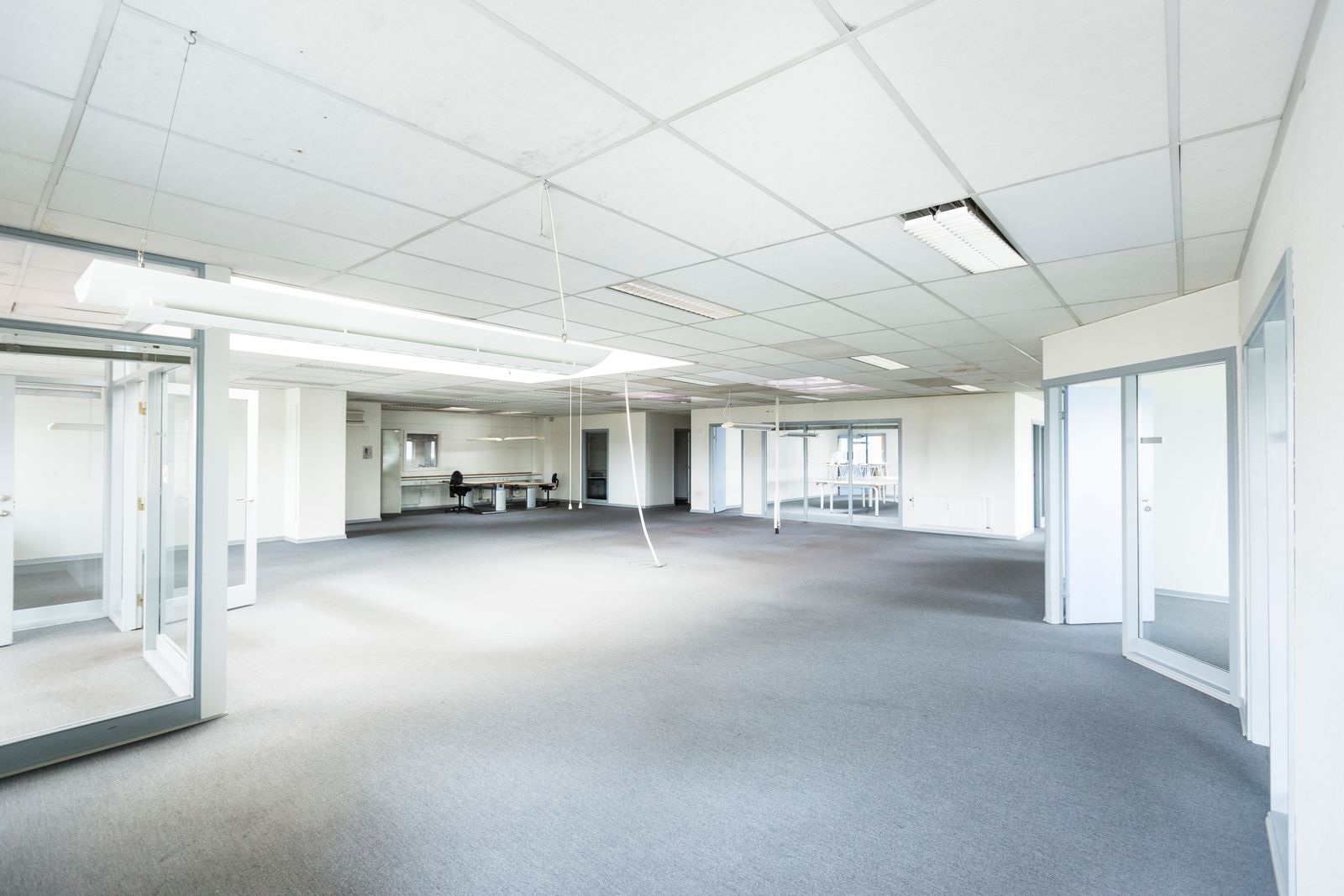 Bright modern empty office interior with glass partitions, ready for the next business day