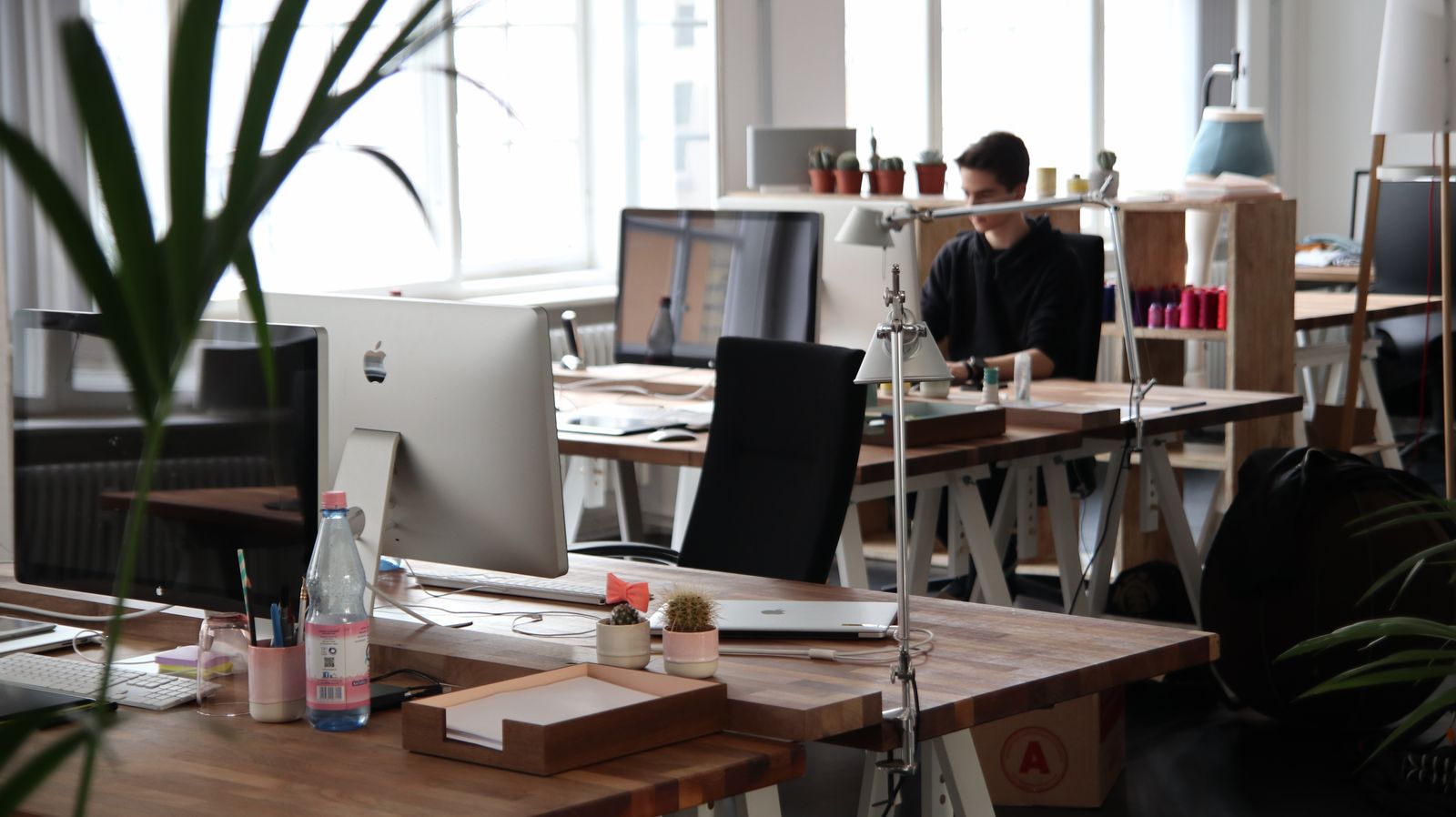 Clean modern office workspace with desks and natural light
